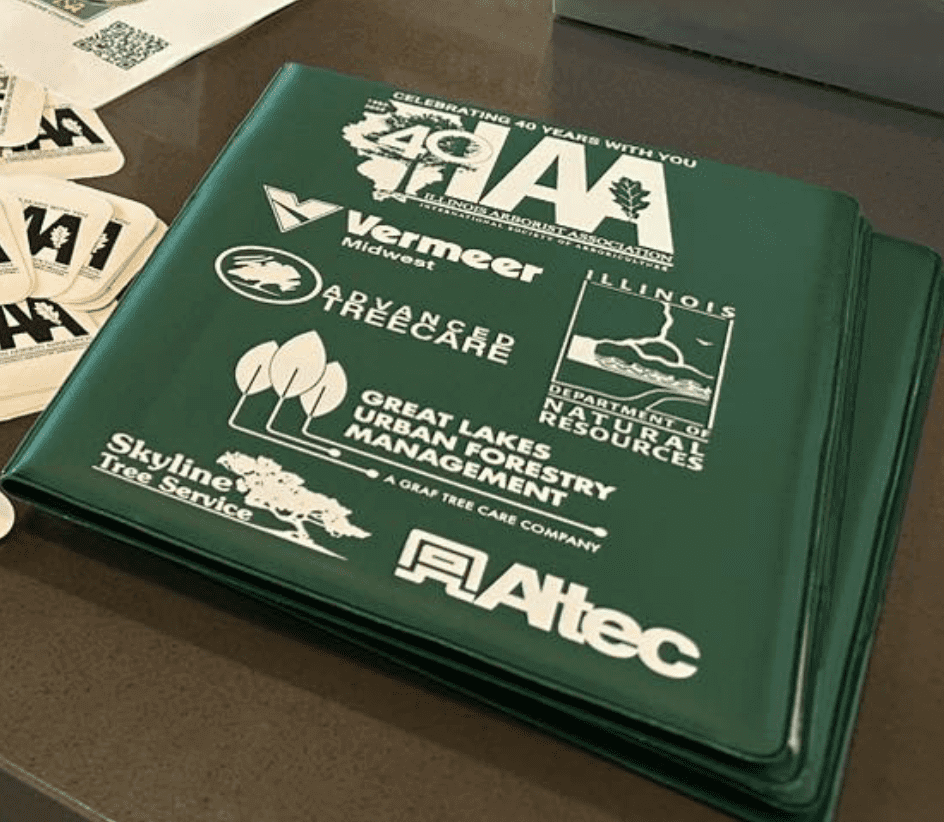 Green folder with various sponsor logos displayed.